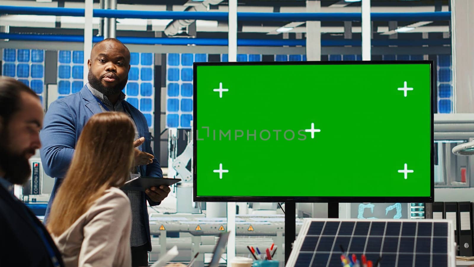 Managers in office reviewing solar technology reports on green screen monitor. Shareholders using mockup display, discussing investment opportunities in green energy production, camera B