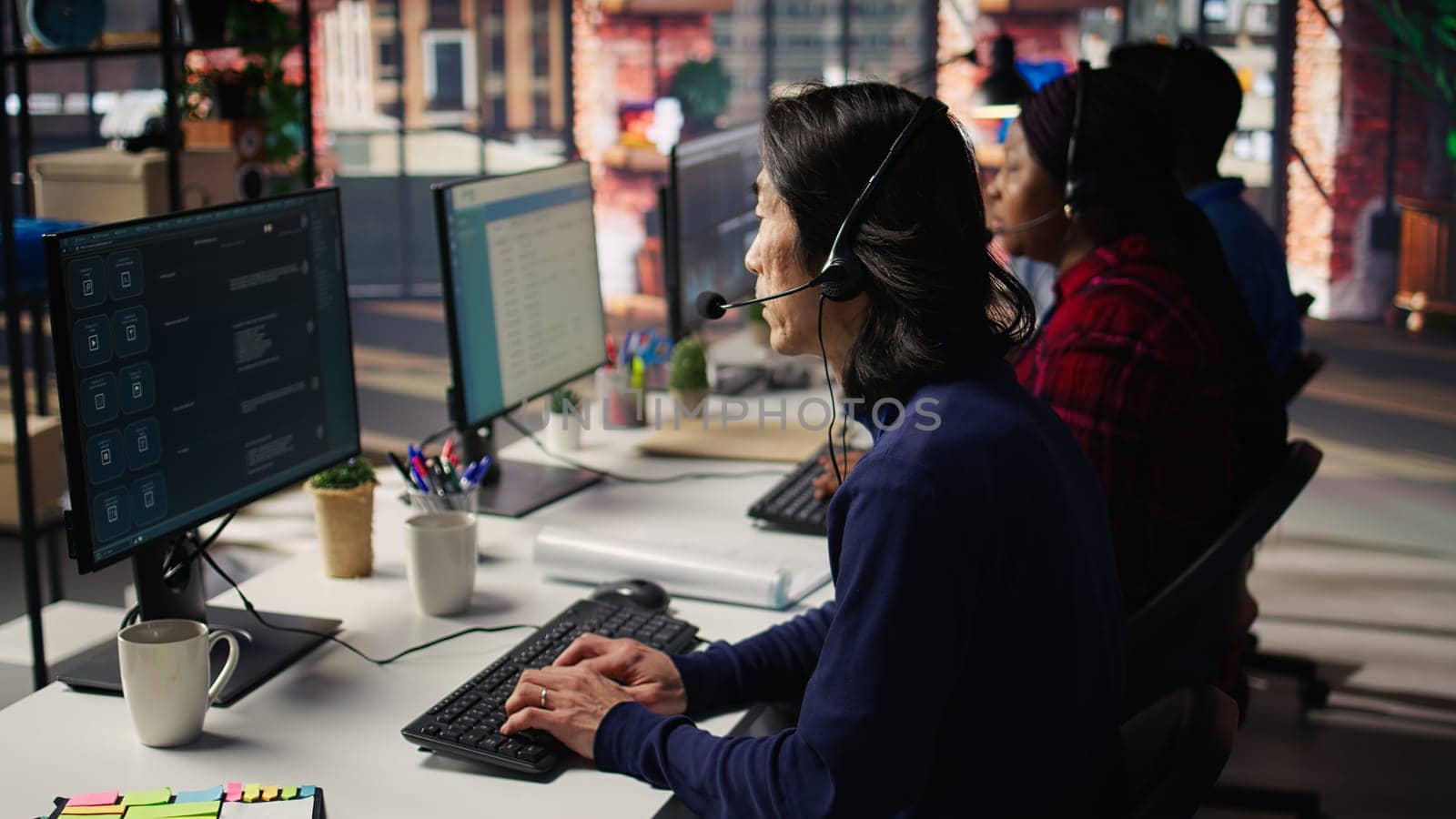 Experienced call center employee listening to customer inquiries and complaints. Asian senior customer service representative assisting customers with issues related to products or services, camera B