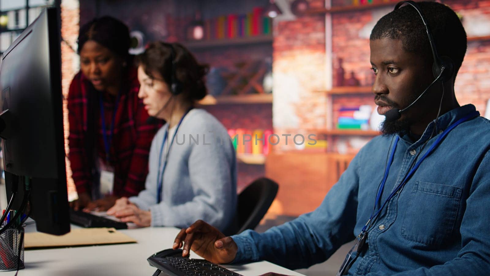 Customer support worker has conversation with client in live chat, providing solutions. Call center agent assists customers through digital communication channels, answering questions, camera B