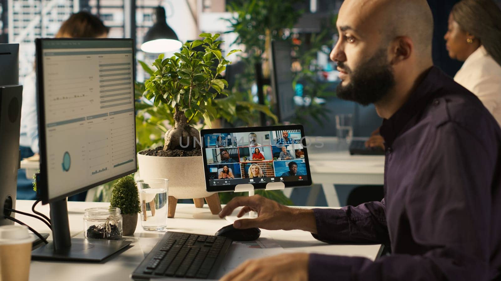 Worker in office talking with colleagues during internet videocall. Employee at work discussing with business partners during remote teleconference meeting, analyzing metrics, camera A
