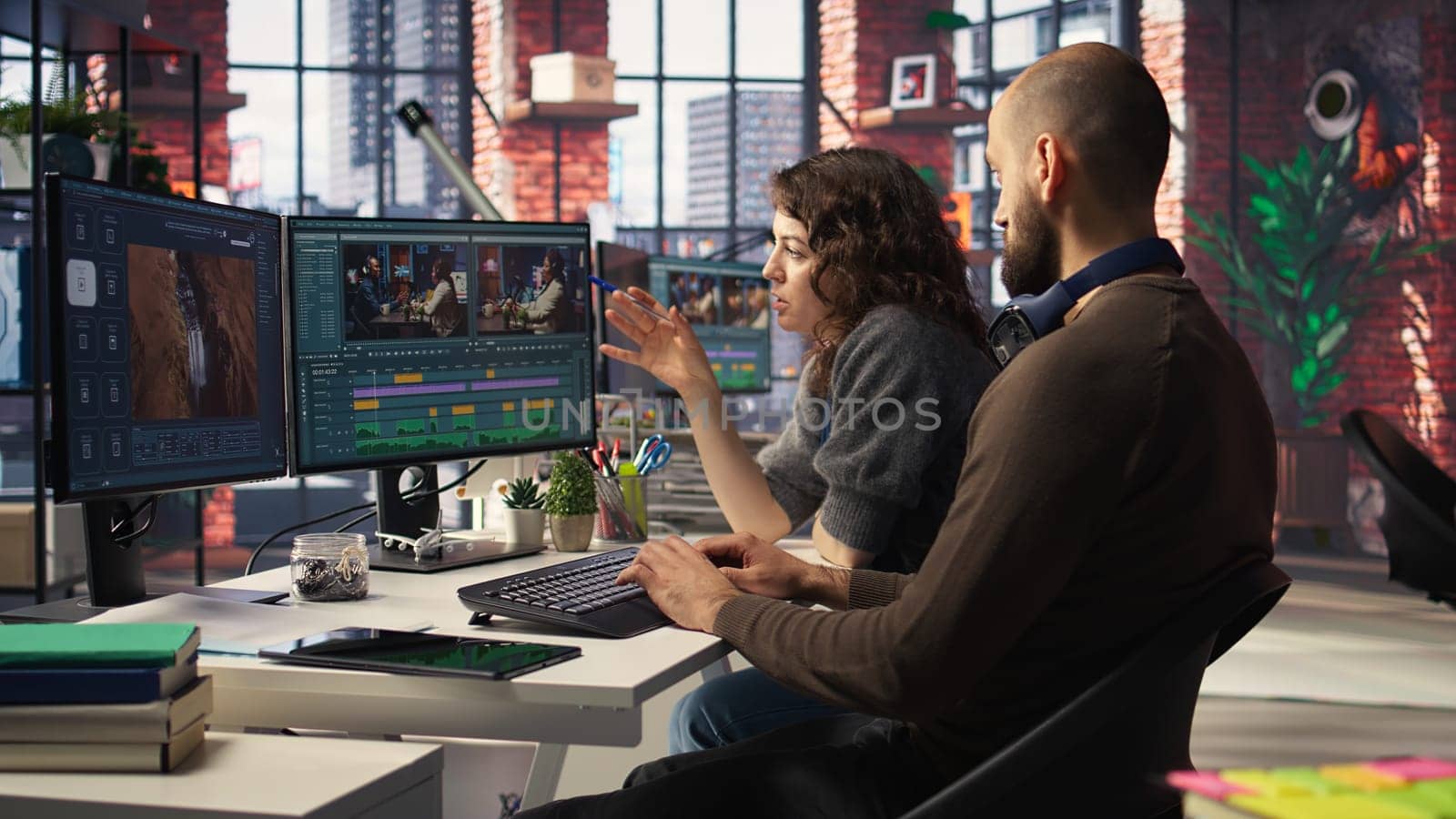 Team of experts editors working in video production industry at agency office, doing color grading and creating a montage on dual monitors. Creative process with multimedia tech tools. Camera A.