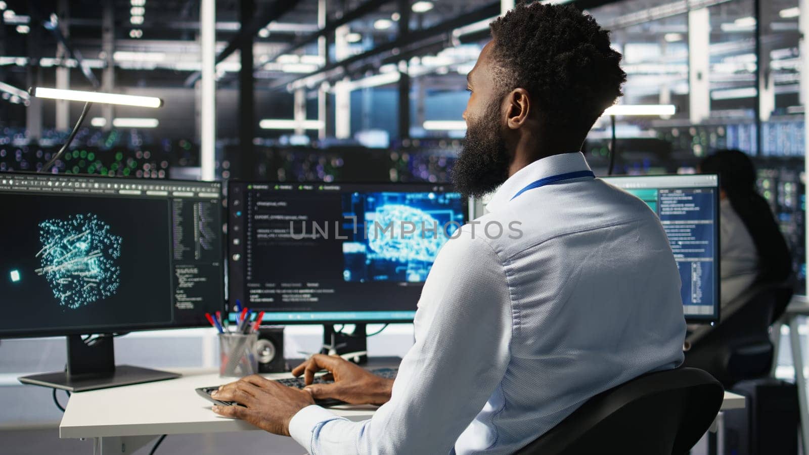 Server hub engineering team interprets AI generated data analytics graphs. Teamworking data center colleagues using artificial intelligence program showing predictive system metrics, camera A
