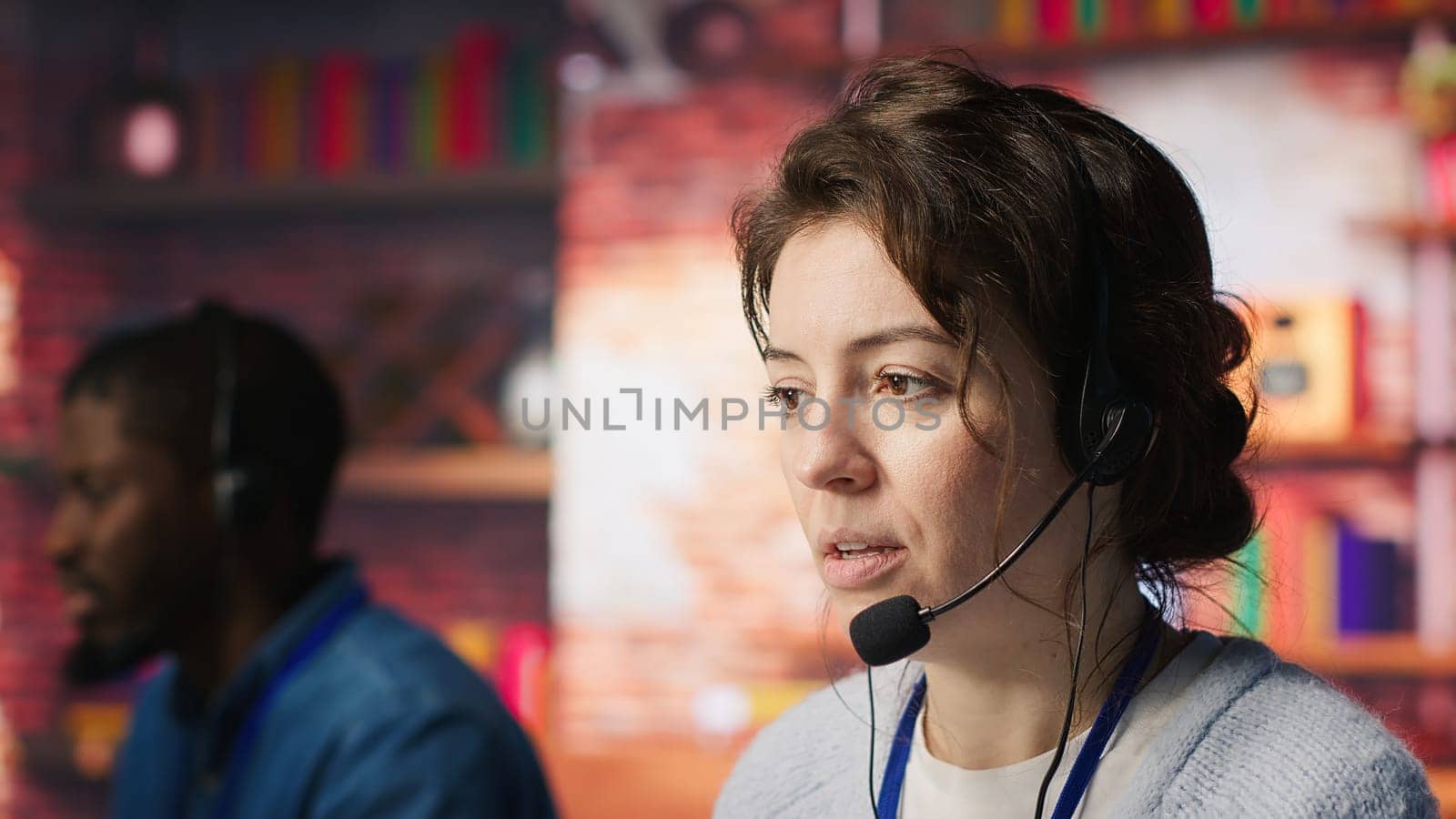 Customer support workers doing upselling, recommending products to clients during conversation. Call center agents contact prospects to inform them about new services and promotions, camera A close up