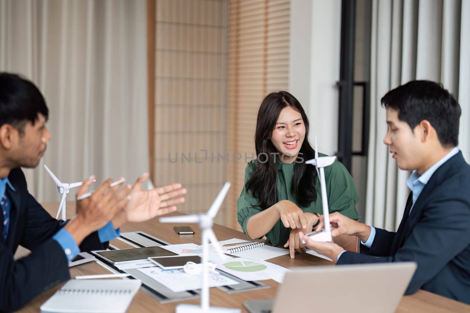 Business team engages in an animated discussion about ESG strategies, emphasizing sustainability and corporate responsibility in a meeting.