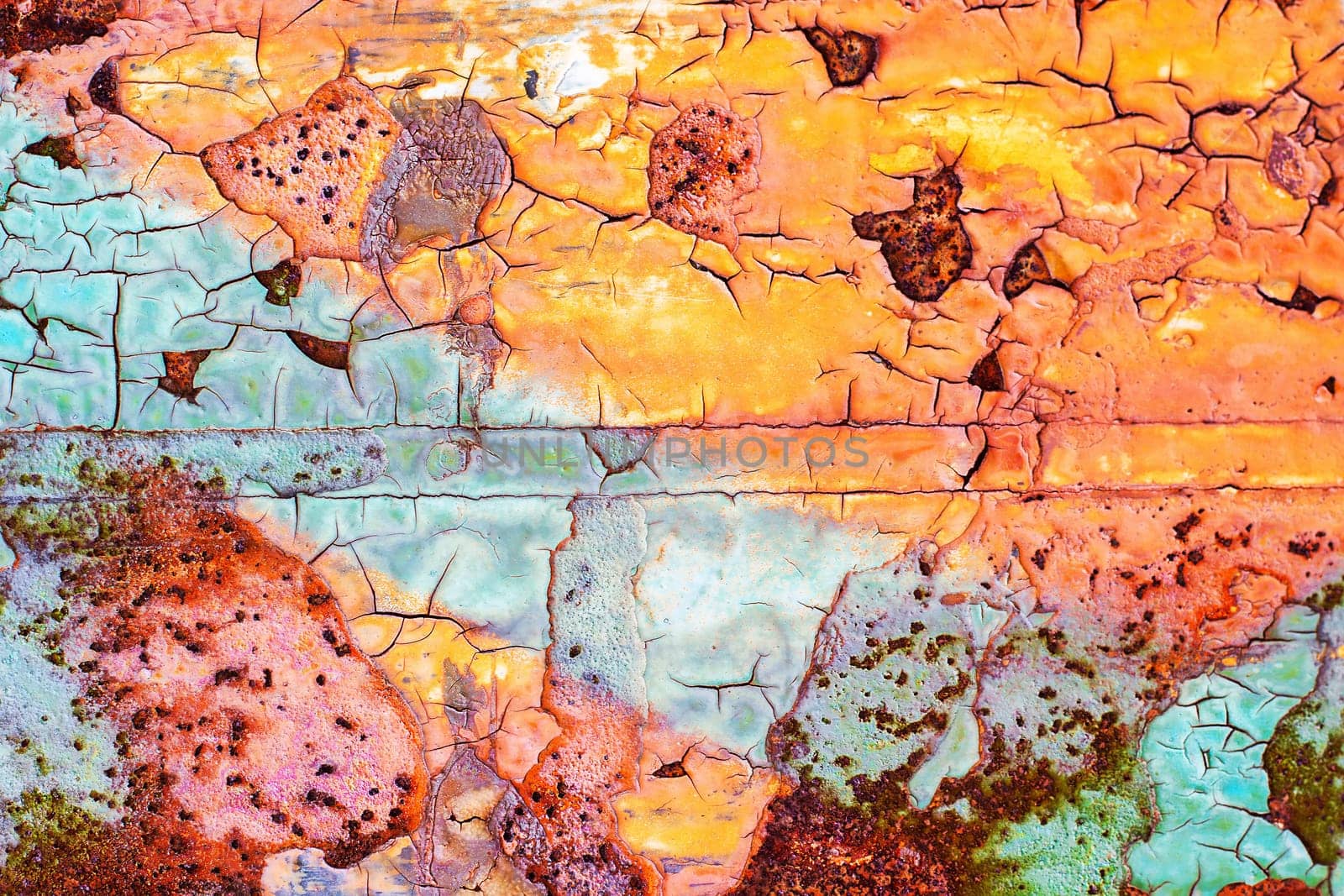 Background of blue and orange cracked old damaged paint texture on a metal surface. High quality photo