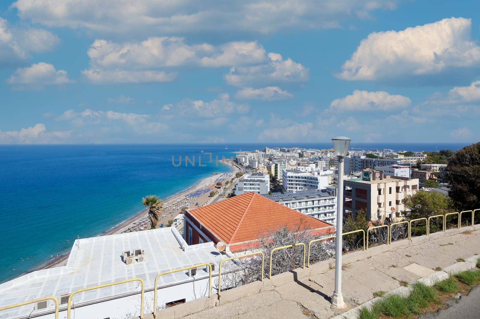 Rhodes. Greece - June 06, 2025: Vibrant scene of Rhodes city from an elevated viewpoint, capturing urban life alongside the serenity of the Mediterranean.