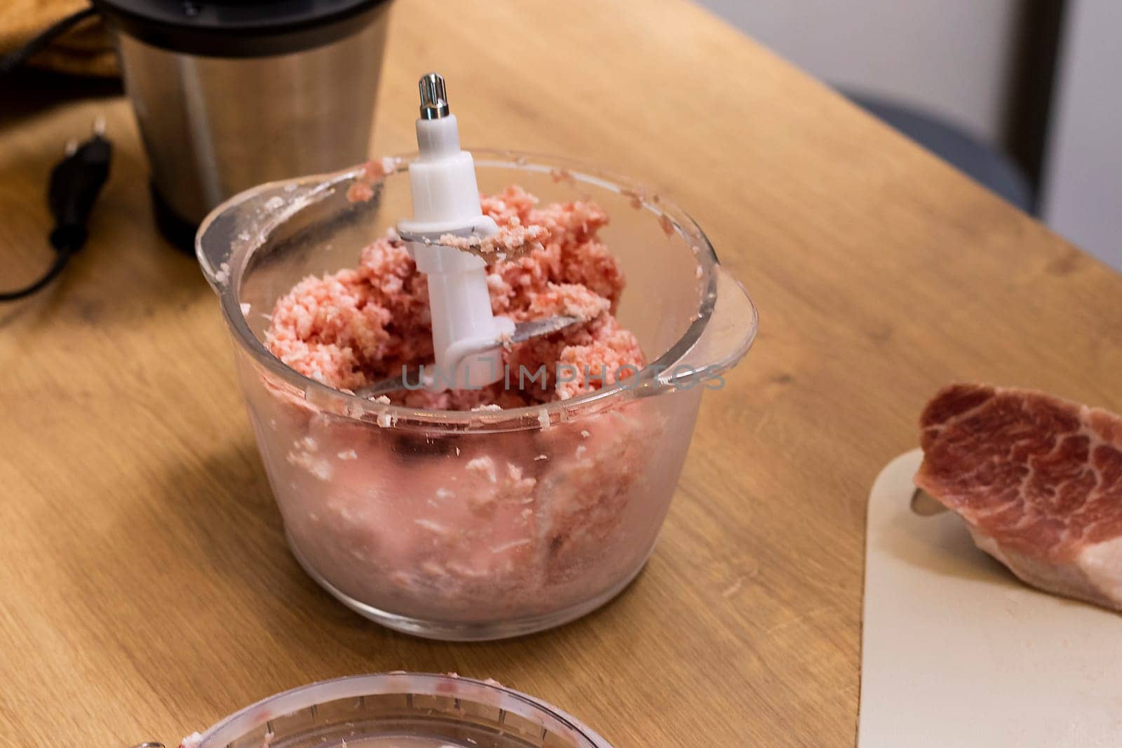 Just ground meat mince in the glass bawl of the electrical chopper on the kitchen counter top