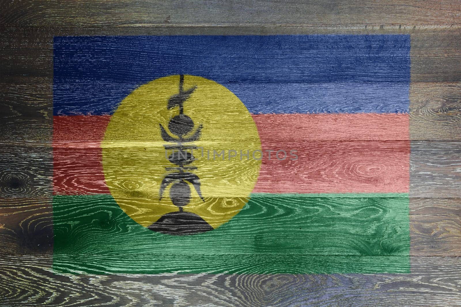 A New Caledonia flag on rustic old wood surface background
