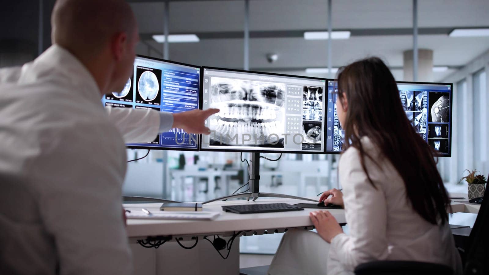 Radiologist Doctors Analyzing Brain MRI Scan On Computer Screen