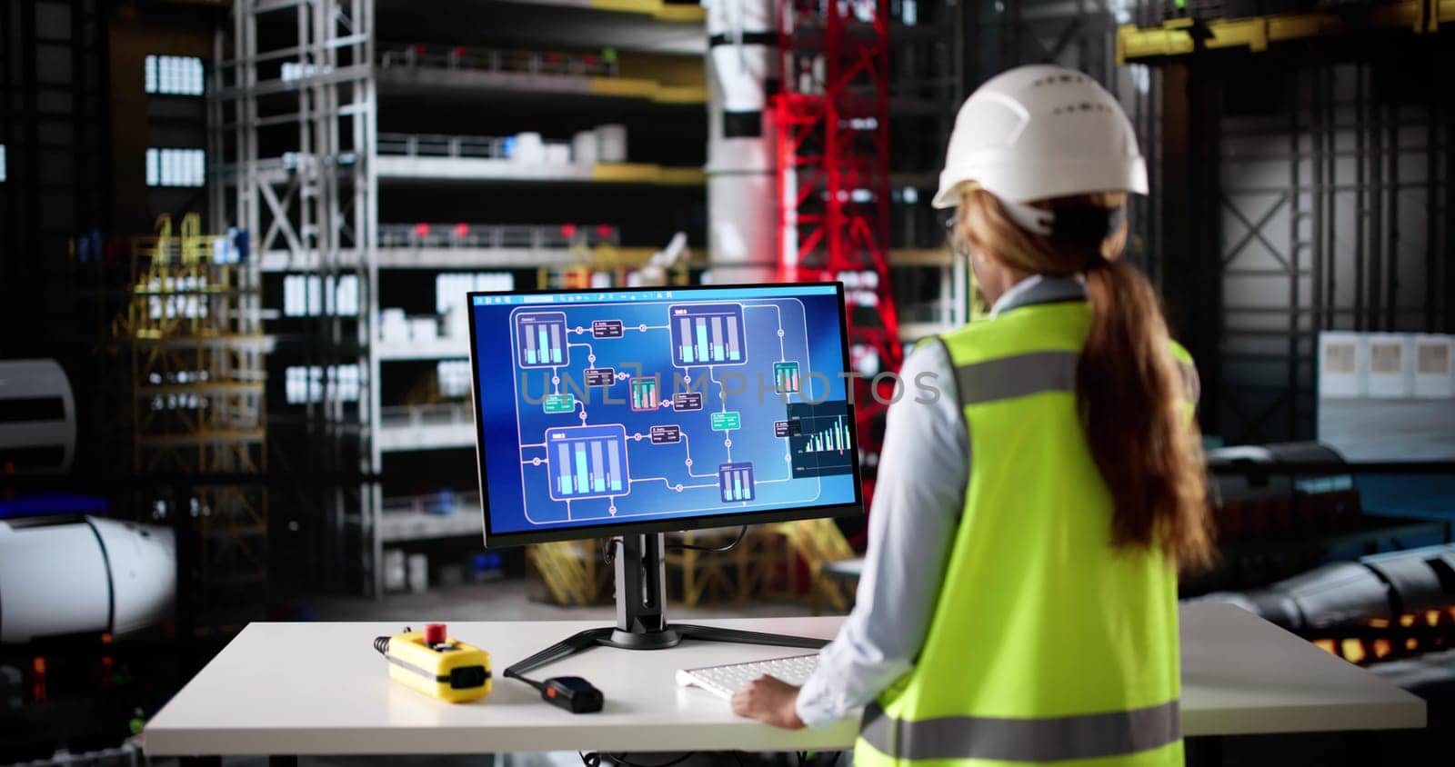 Woman Engineer Monitors Factory Operations Using Industrial Technology At Control Center.