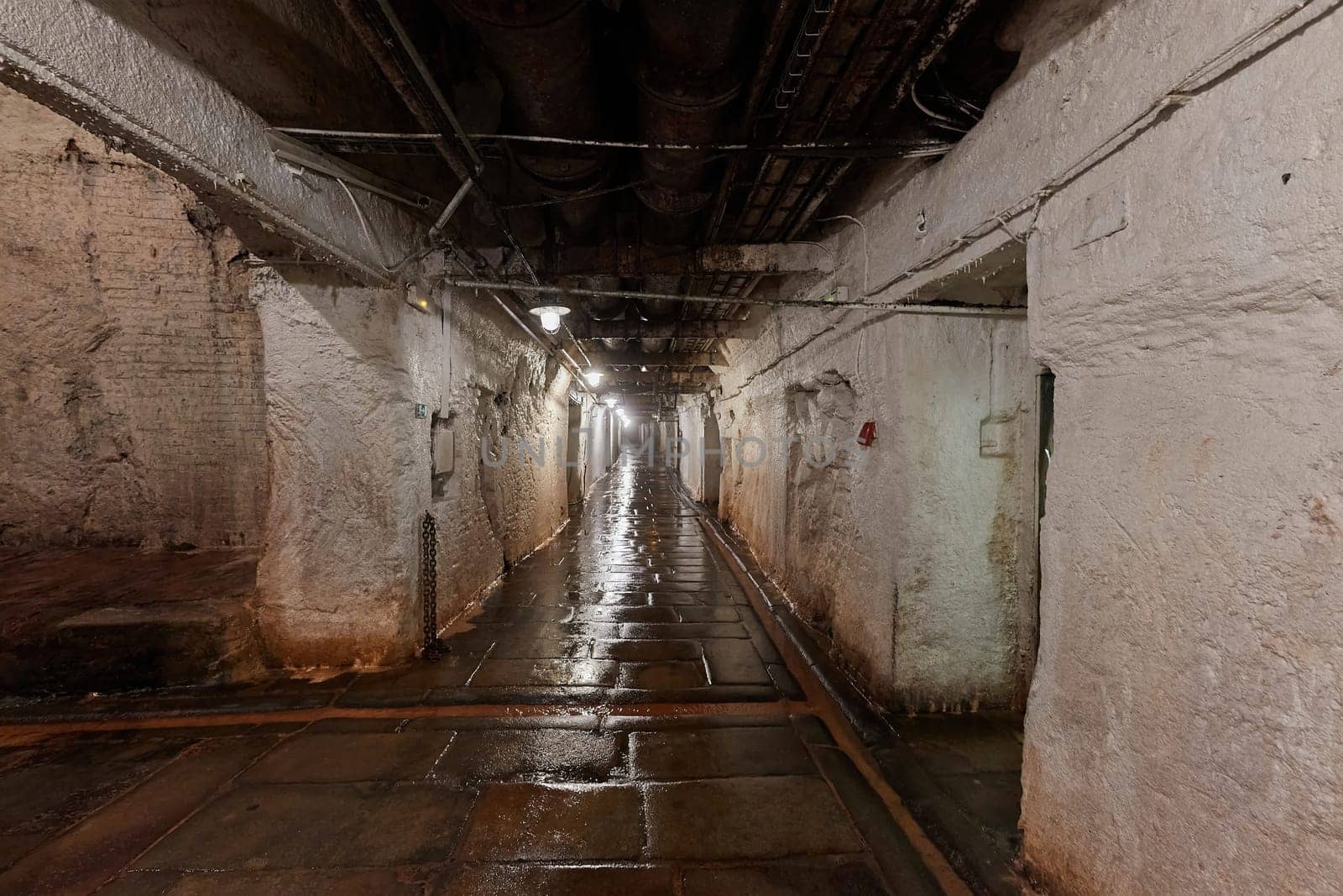 Underground bunker tunnel with wet floor and system of halls and corridors