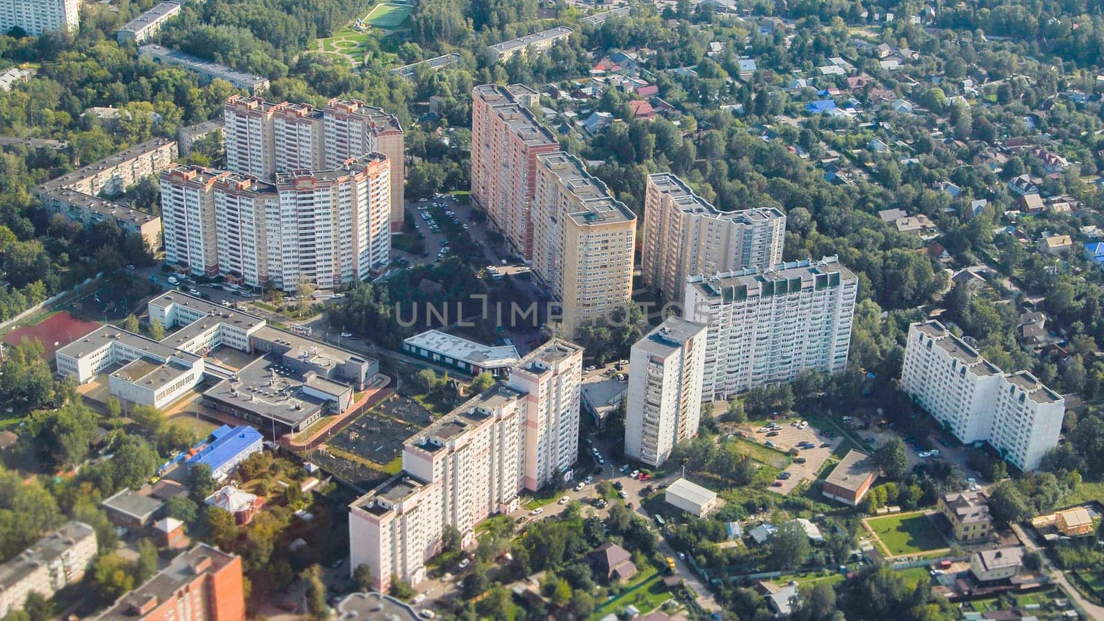 High-angle view showcasing urban landscape of Zelenograd, featuring residential buildings, schools, and green areas