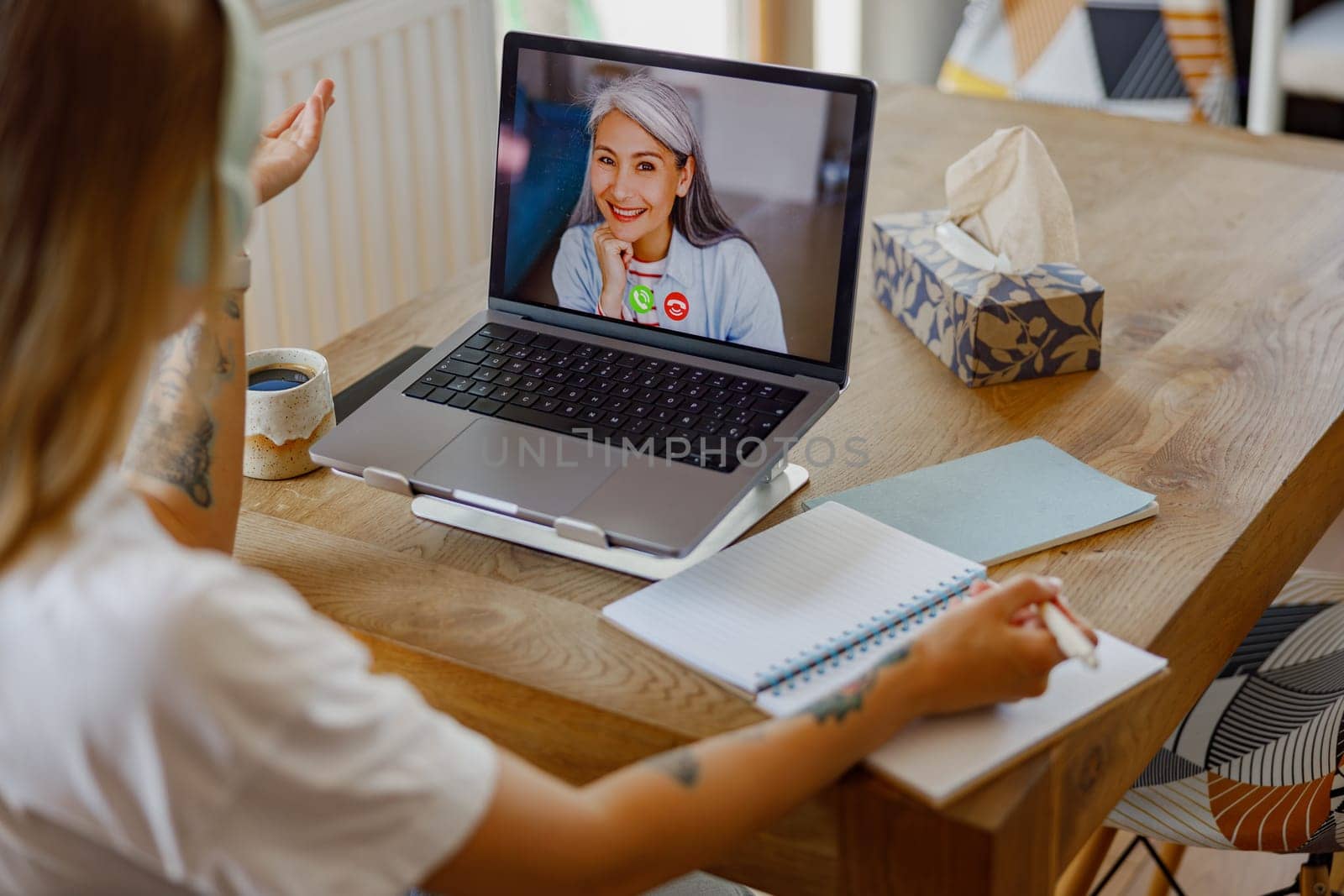 A relaxed and casual virtual meeting with friends over coffee while using a laptop, showcasing modern communication