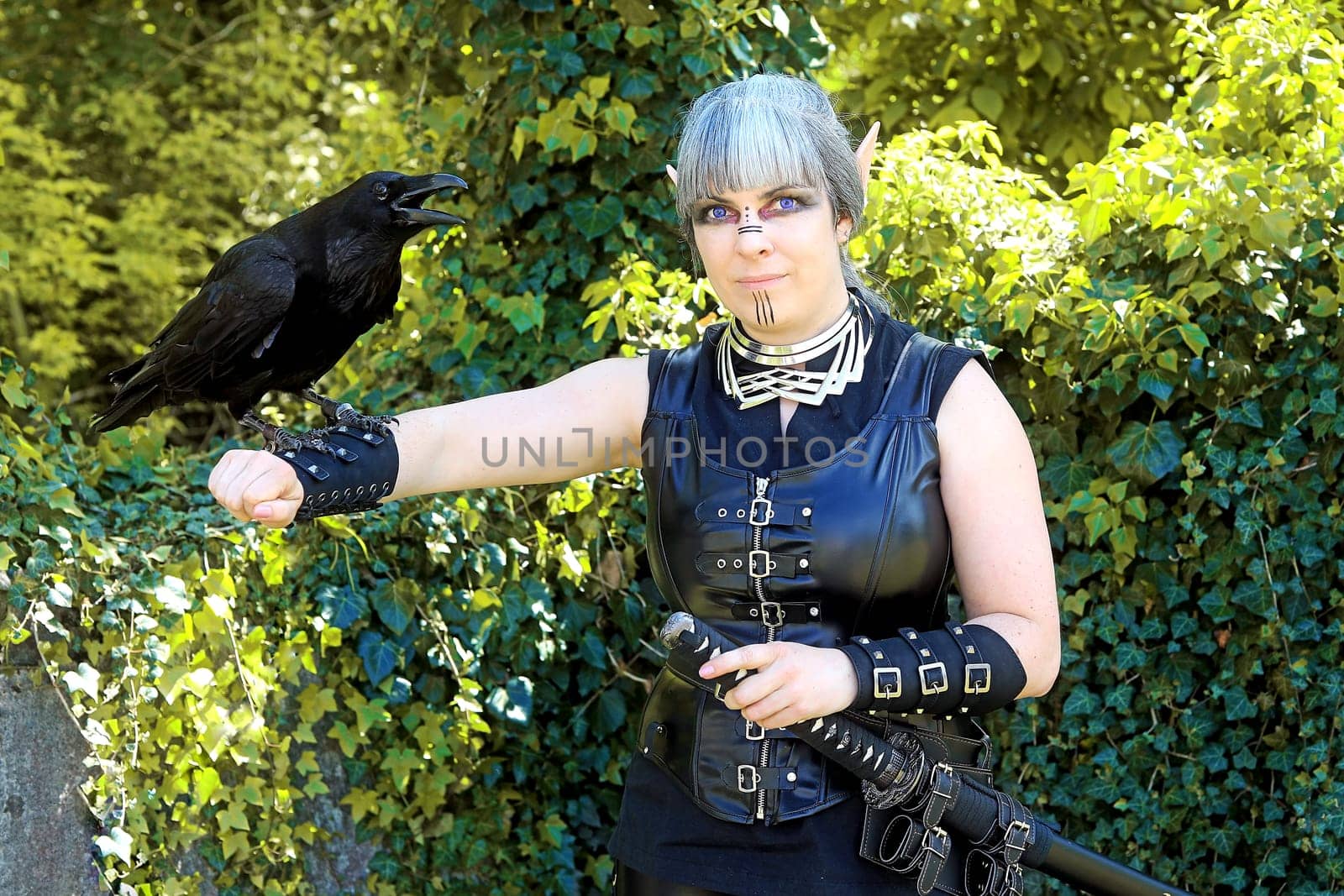 Fantasy photo of a dark elf with a raven on her hand