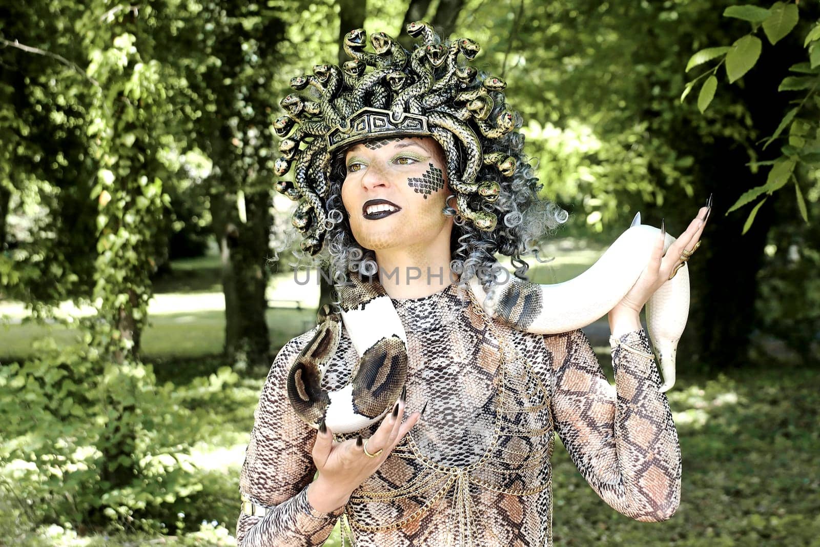 A woman dressed as Medusa with a snake around her neck
