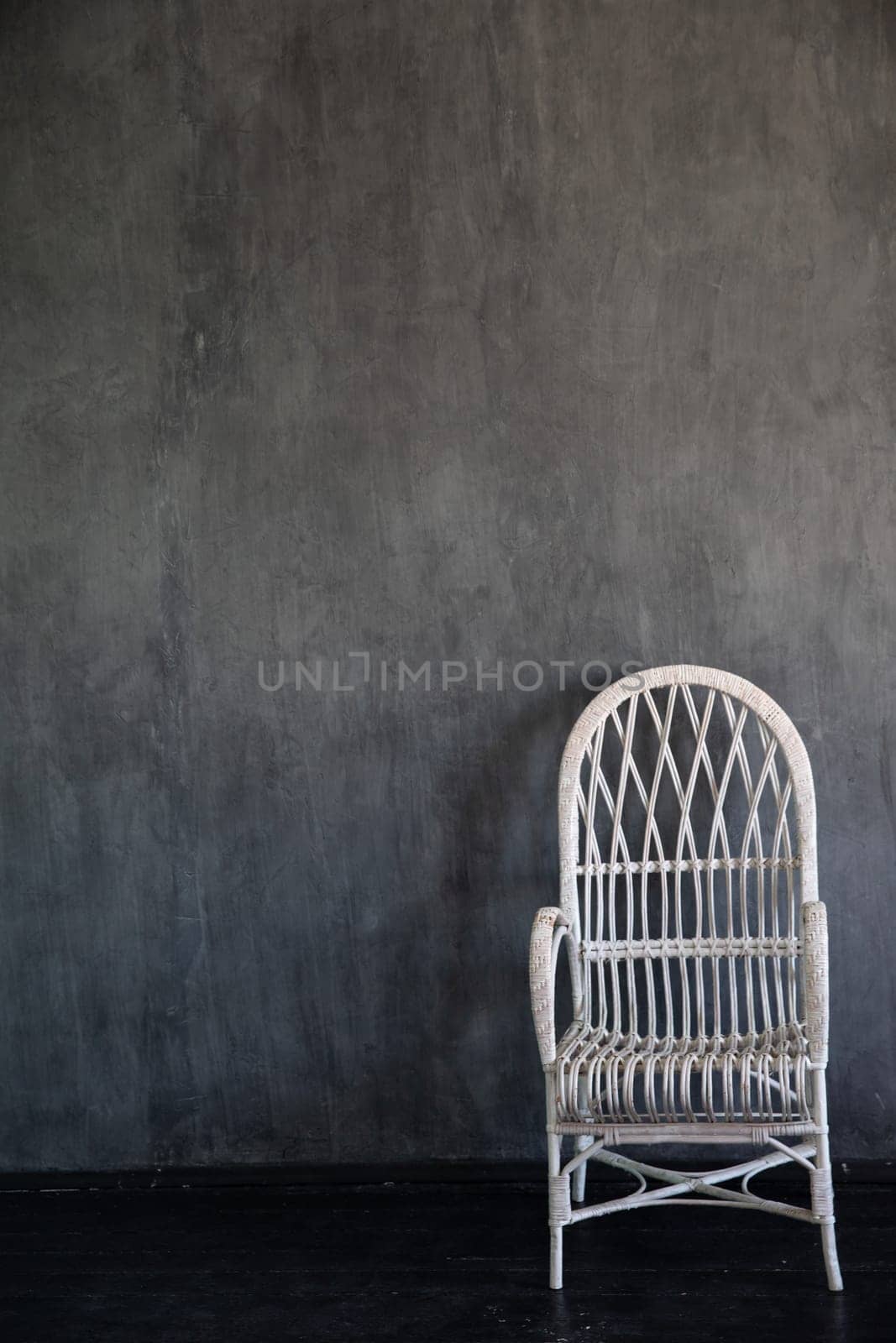 White vintage armchair in the interior of a gray room