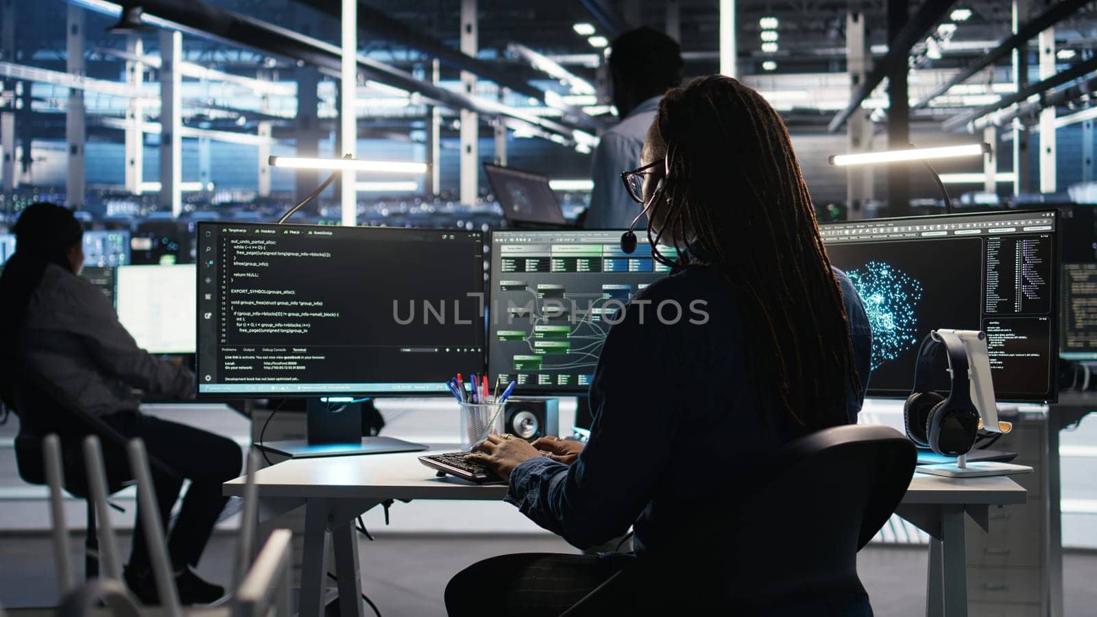 Data center expert examines node tree interface, delivering technical support. Server room technician talking in headset mic with coworkers, using visual programming software, camera A