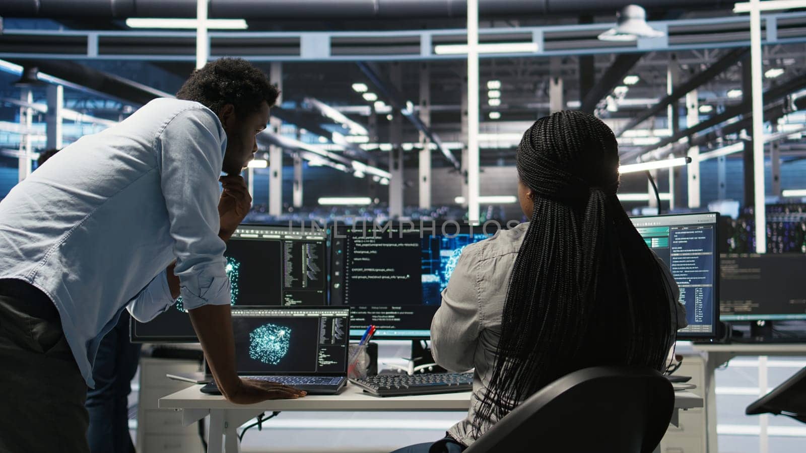 Data center manager supervising worker deploying AI solutions optimizing equipment. Server farm supervisor overseeing programmer using artificial intelligence to minimize systems downtime, camera A