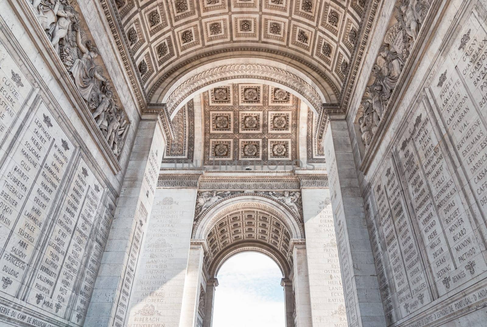 France, Paris - May 03, 2025 - The magnificent details of ornate stone carvings under the arch of the famous Arc de Triomphe. Iconic touristic architectural landmark of Paris, use it as your Wallpaper, Poster and Space for text, Selective focus.