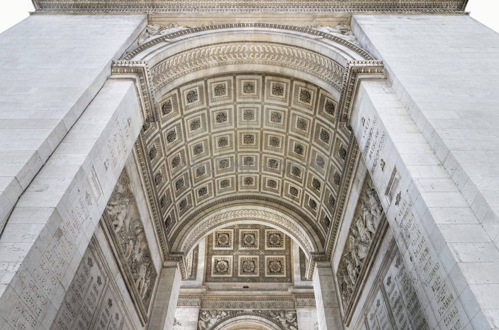 France, Paris - May 03, 2025 - The stunning details of ornate stone carvings under the arch of the famous Arc de Triomphe. Iconic touristic architectural landmark of Paris, use it as your Wallpaper, Poster and Copy space, Selective focus.