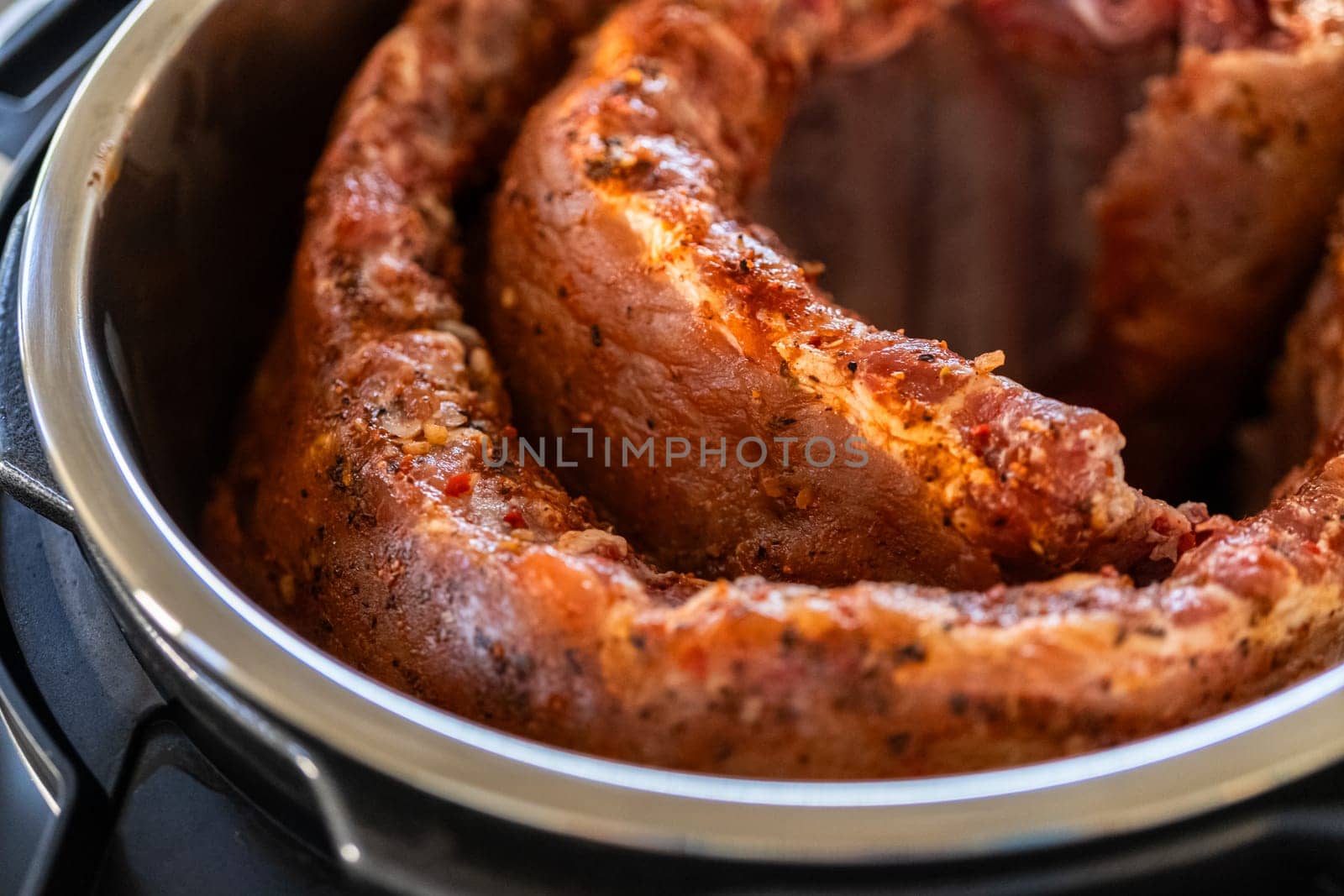 In a sleek modern kitchen, were adding an extra layer of flavor to succulent baby back ribs by infusing them with a medley of spices in a multicooker-a mouthwatering feast in the making.