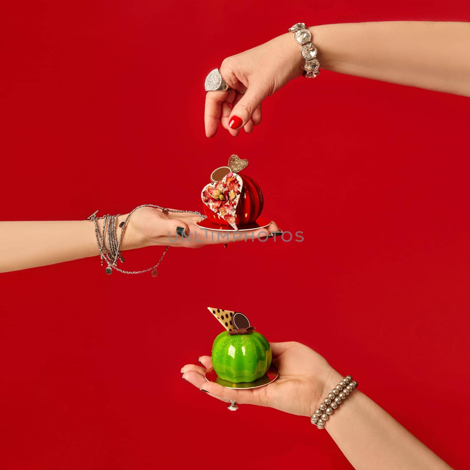 Women's hands presenting delicious heart-shaped desserts, showcasing culinary expertise and valentine's day treats