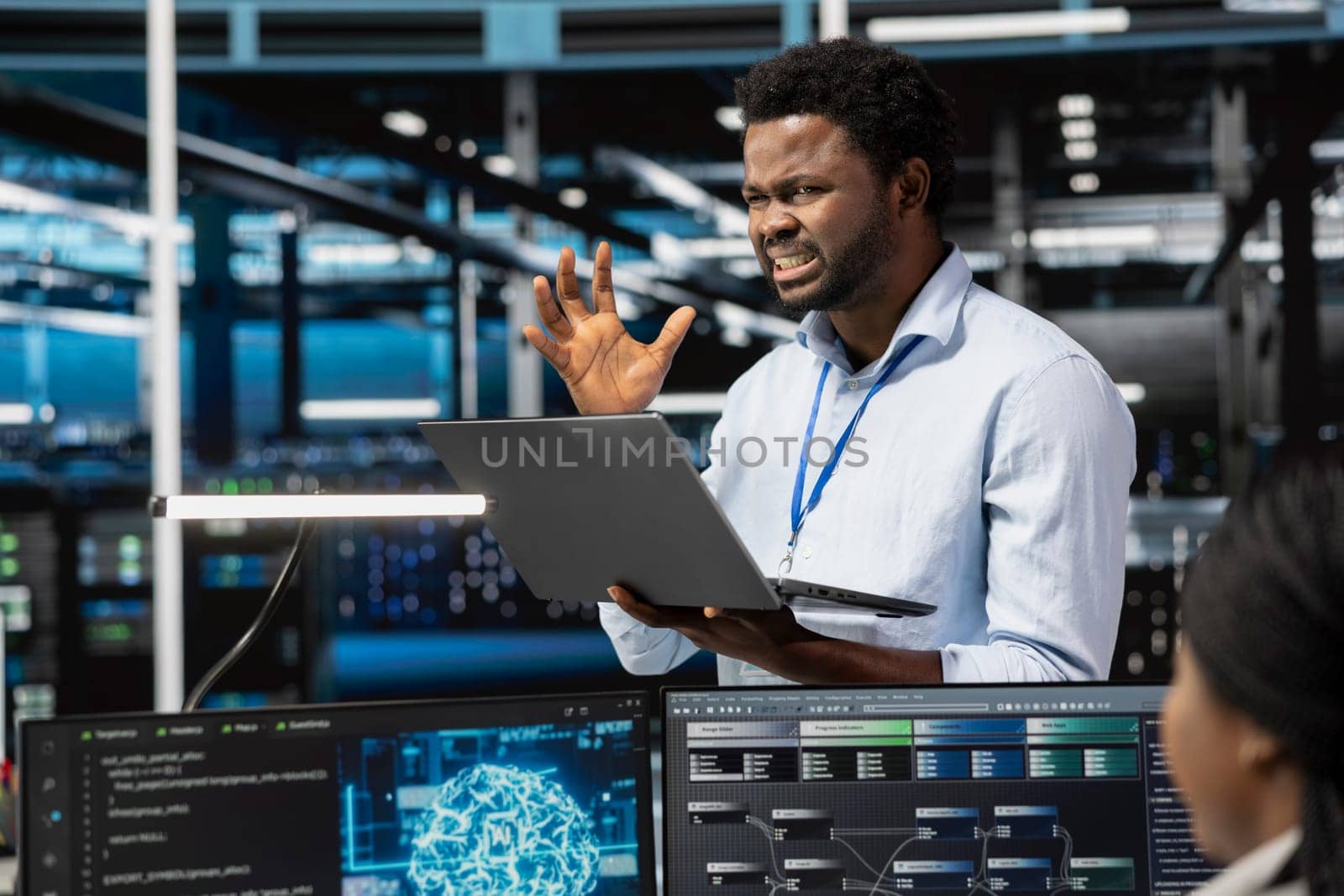 Frustrated technician angered by glitching data center equipment needed to run artificial intelligence and machine learning. Annoyed server room worker irked by errors while using AI tools