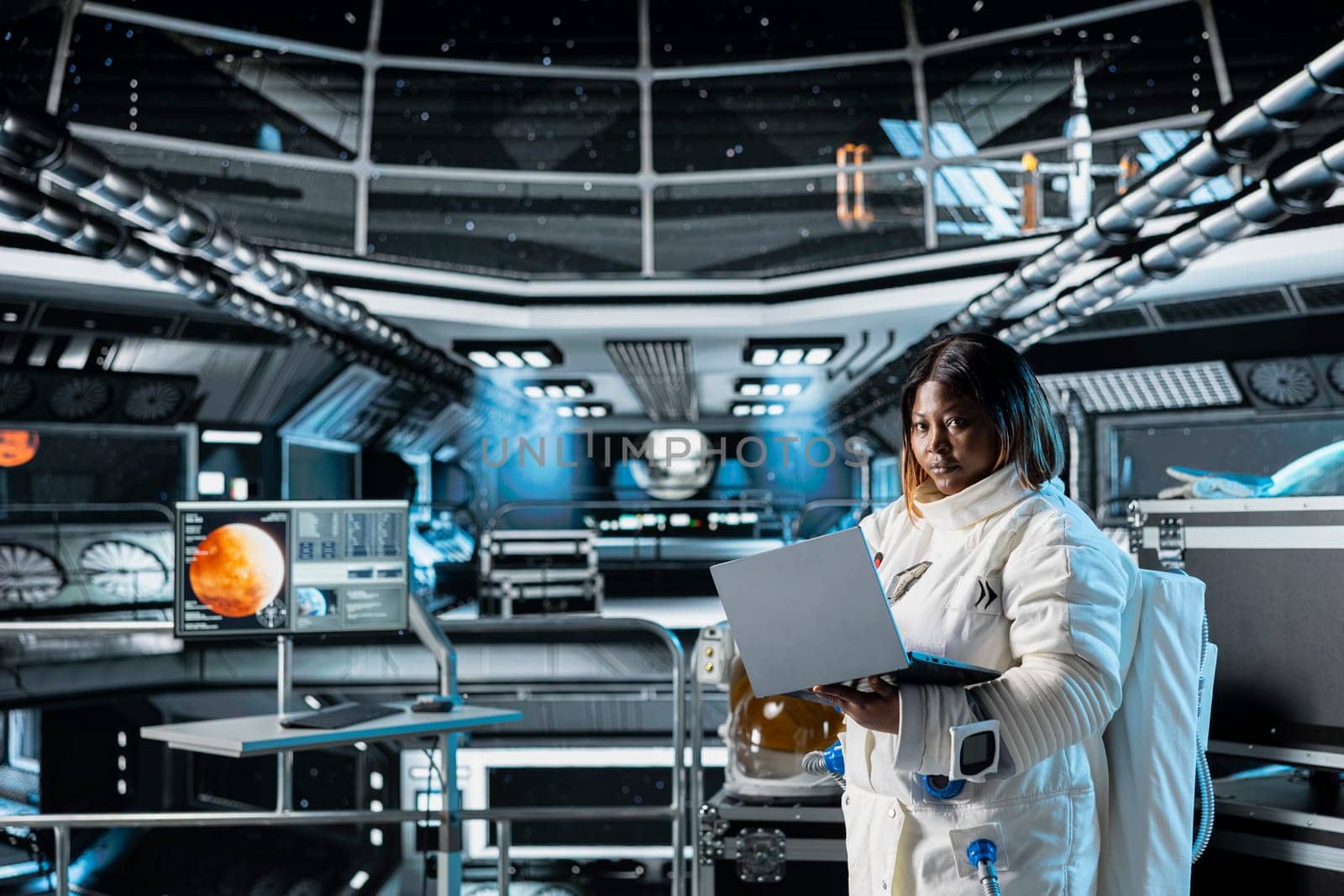 Female cosmonaut monitoring system diagnostics on laptop before Mars expedition. African american astronaut in spaceship explores red planet to support human life beyond Earth