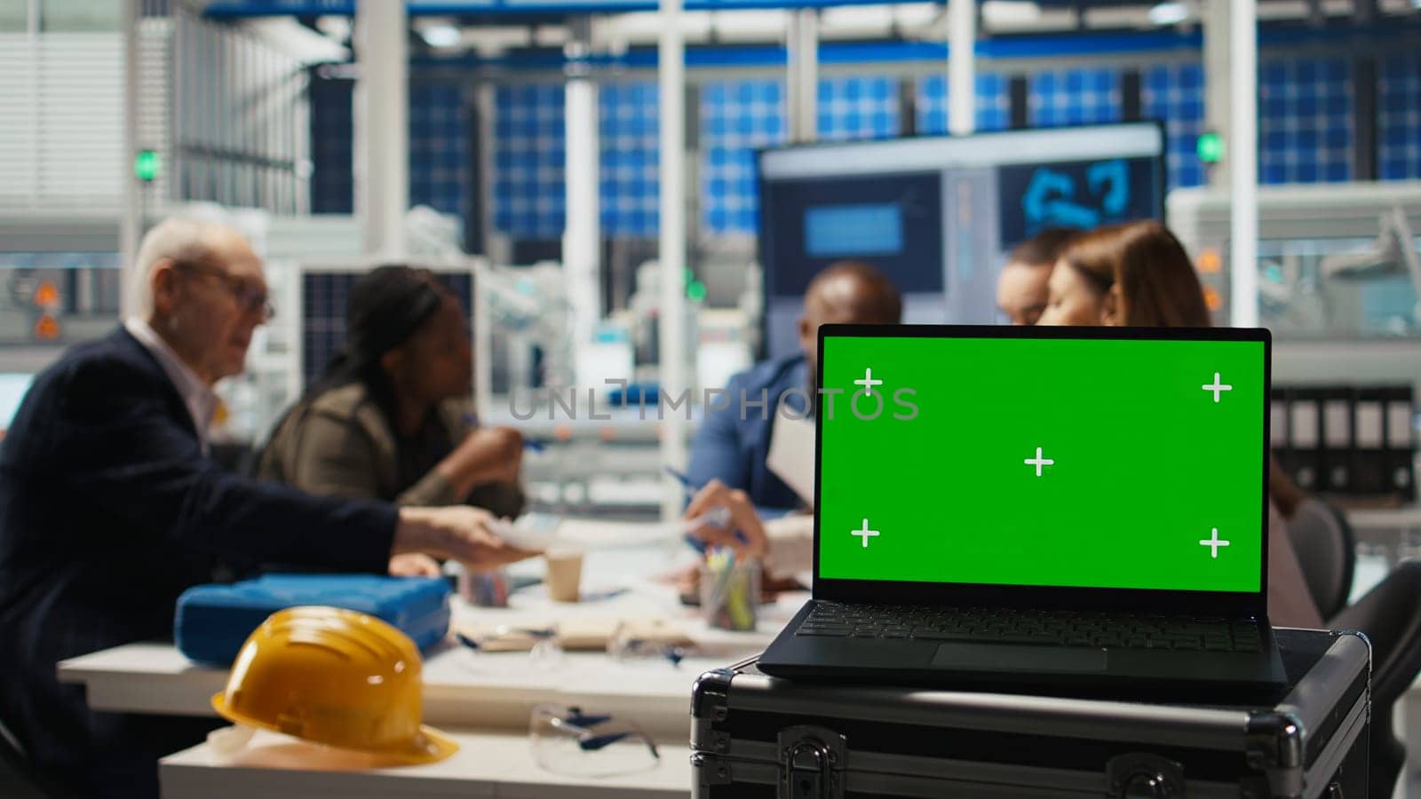 Factory scientists doing research and development, working on manufacturing automation using mockup laptop. Industrial plant experts analyze technical data on chroma key notebook, camera A