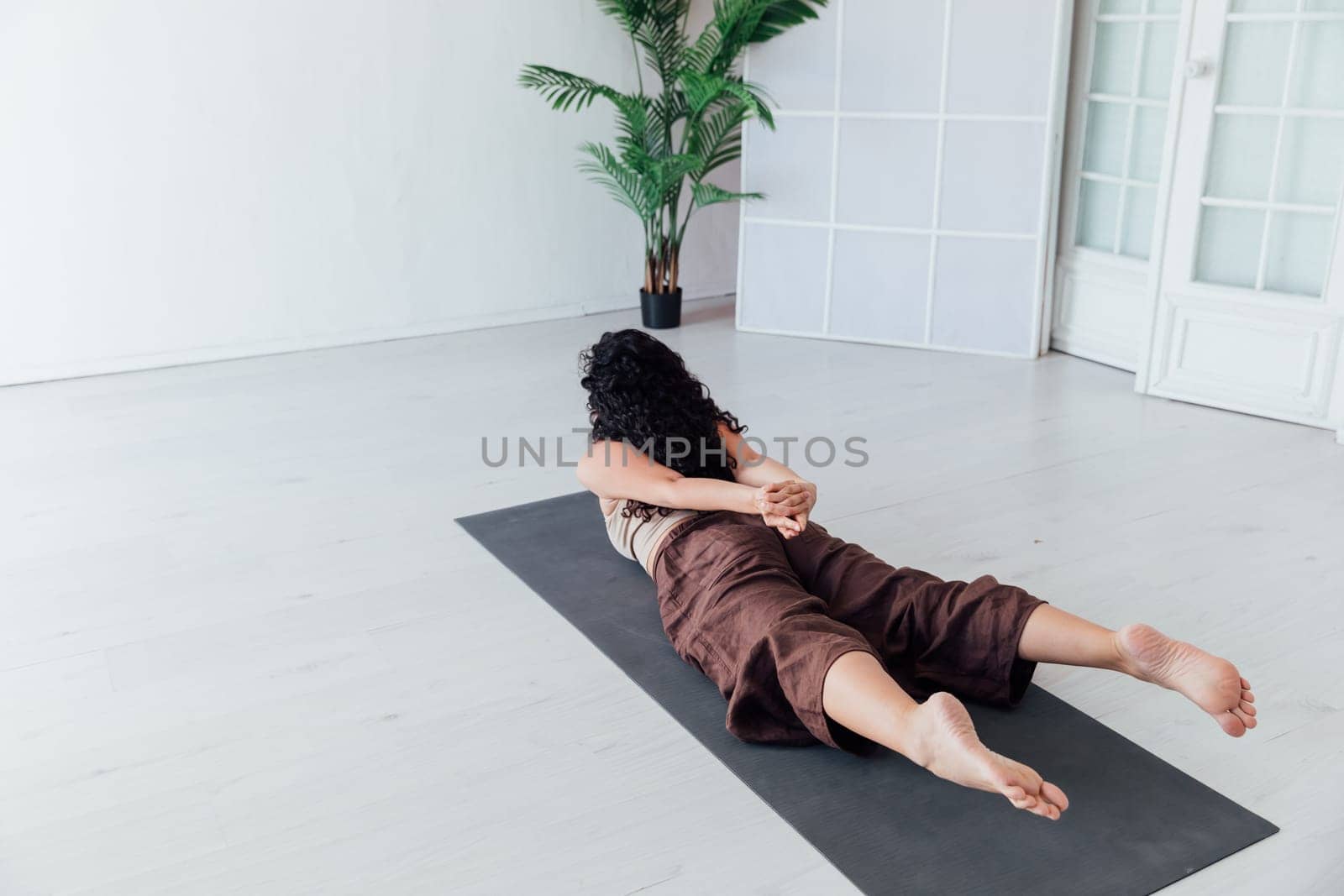 Sports Fitness Woman Brunette Doing Gymnastics Yoga Asana in White Hall