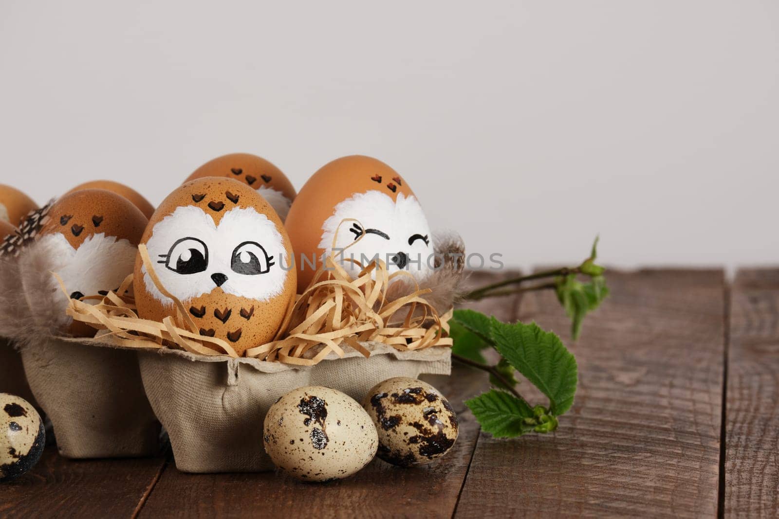 Funny owl family. Hand drawn owl Easter eggs, quail eggs and bird feathers. Space for your text.
