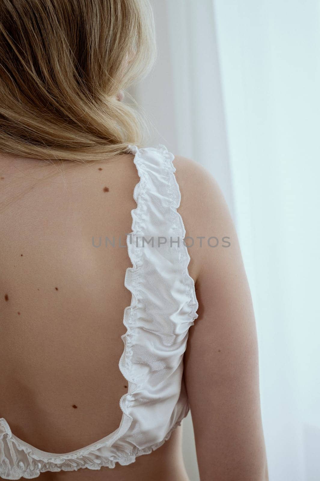 view from the back, top shawl on girl. white silk top and girl's back.