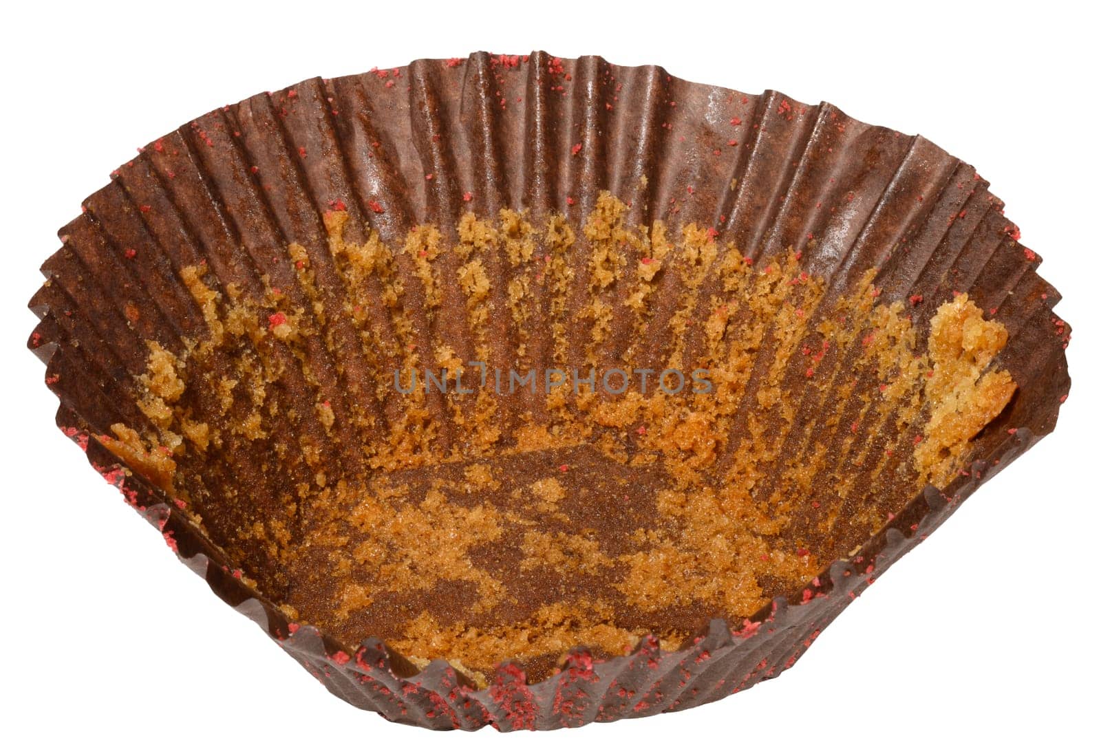 Empty brown paper cupcake or muffin tin with chocolate residue, isolated background