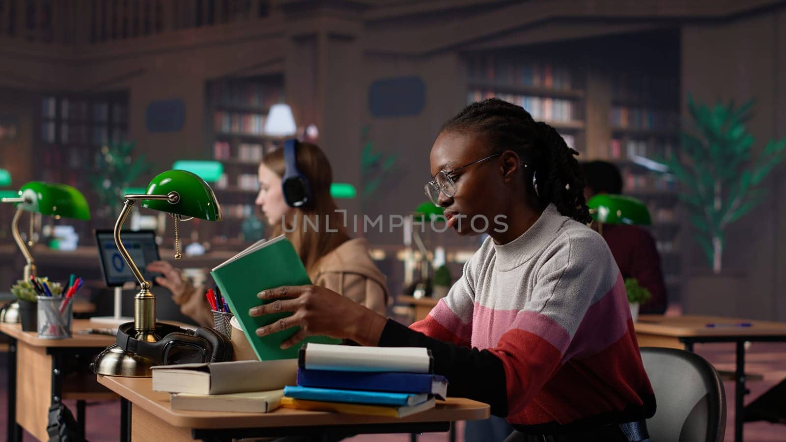 Confident student gathers information and citations from reliable sources via massive database at university library, working on bachelor degree paper. Intelligent girl studies. Camera A.