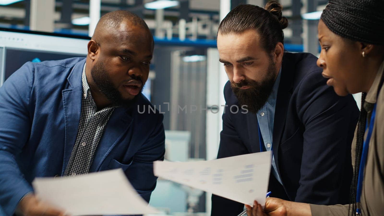 Businesspeople in factory do financial investments, reading documentation files. Management executives look at automation strategies paperwork documents for solar panel production scaling, camera B