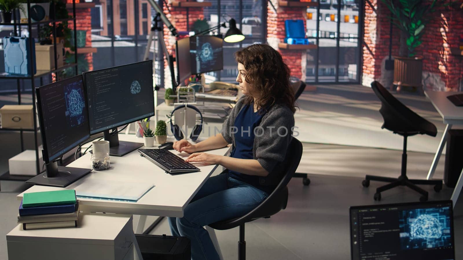Woman IT developer using pc setup for artificial intelligence cloud computing through self learning algorithms. Agency system engineer works with AI deep neural networks on desktop. Camera A.