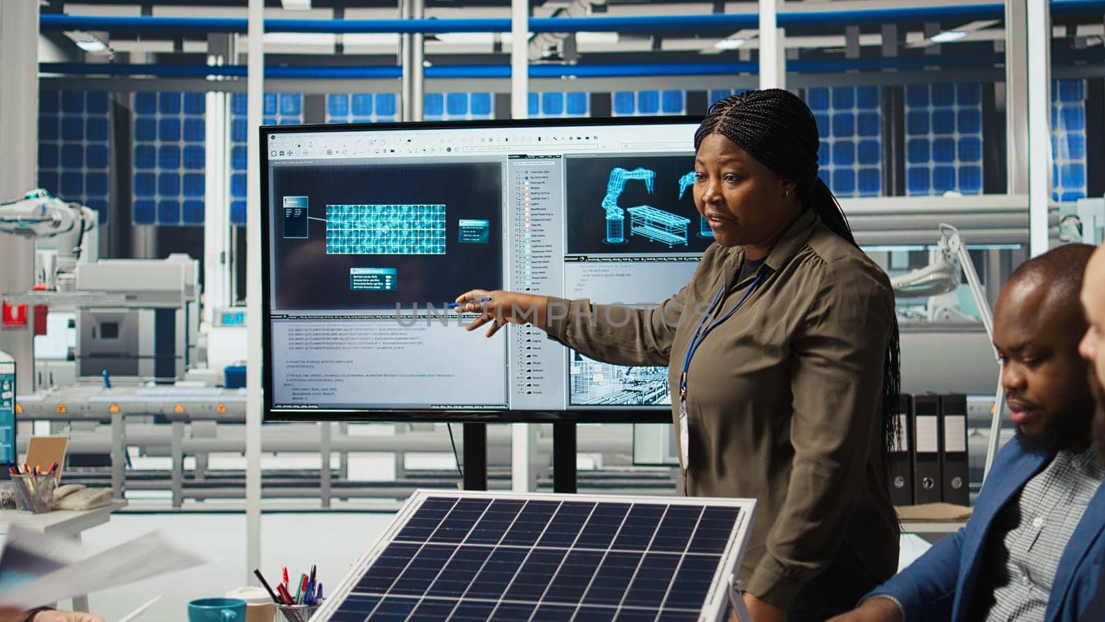 Shareholders discussing future investment opportunities in sustainable energy manufacturing. Management executives and investors in solar panels plant reviewing solar technology reports, camera A
