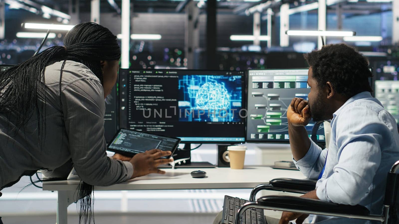 Admin in wheelchair and data center coworker working together using AI node tree software to minimize downtime. Server hub IT expert in disability and colleague using visual programming app, camera B