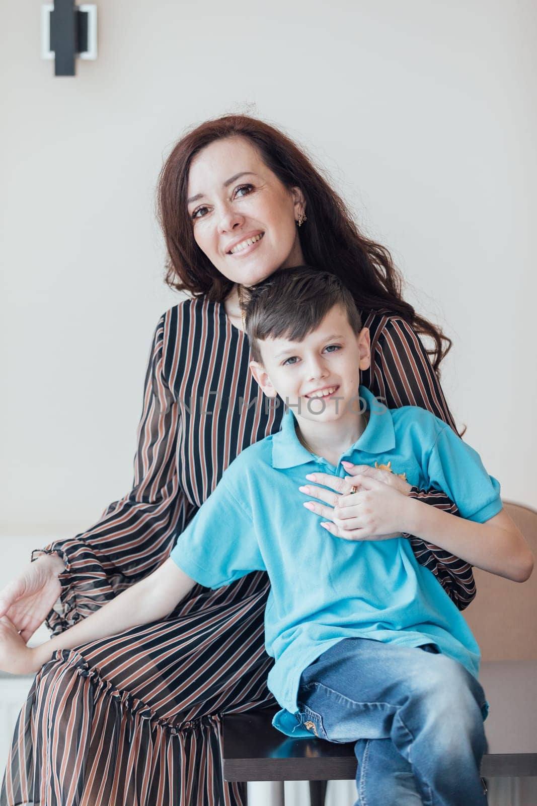 Mom hugging little son smiling