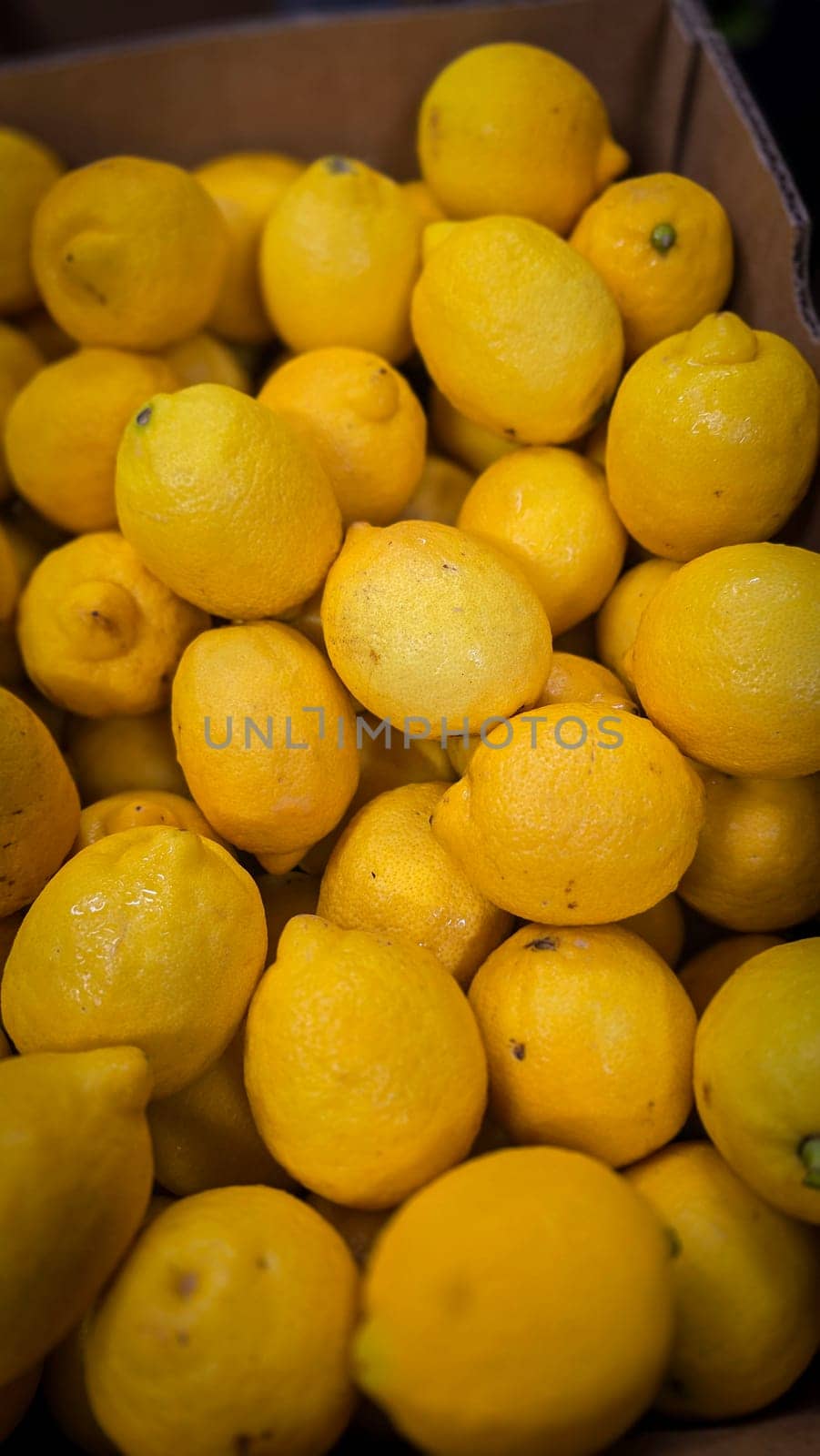 Bright yellow lemons grouped together, presenting an inviting and fresh appearance suitable for culinary or beverage uses, evoking sunny and refreshing vibes. Lemon stack. A vibrant image of fresh, ripe lemons top view. Rich vitamin c, natural and fresh lemon stack