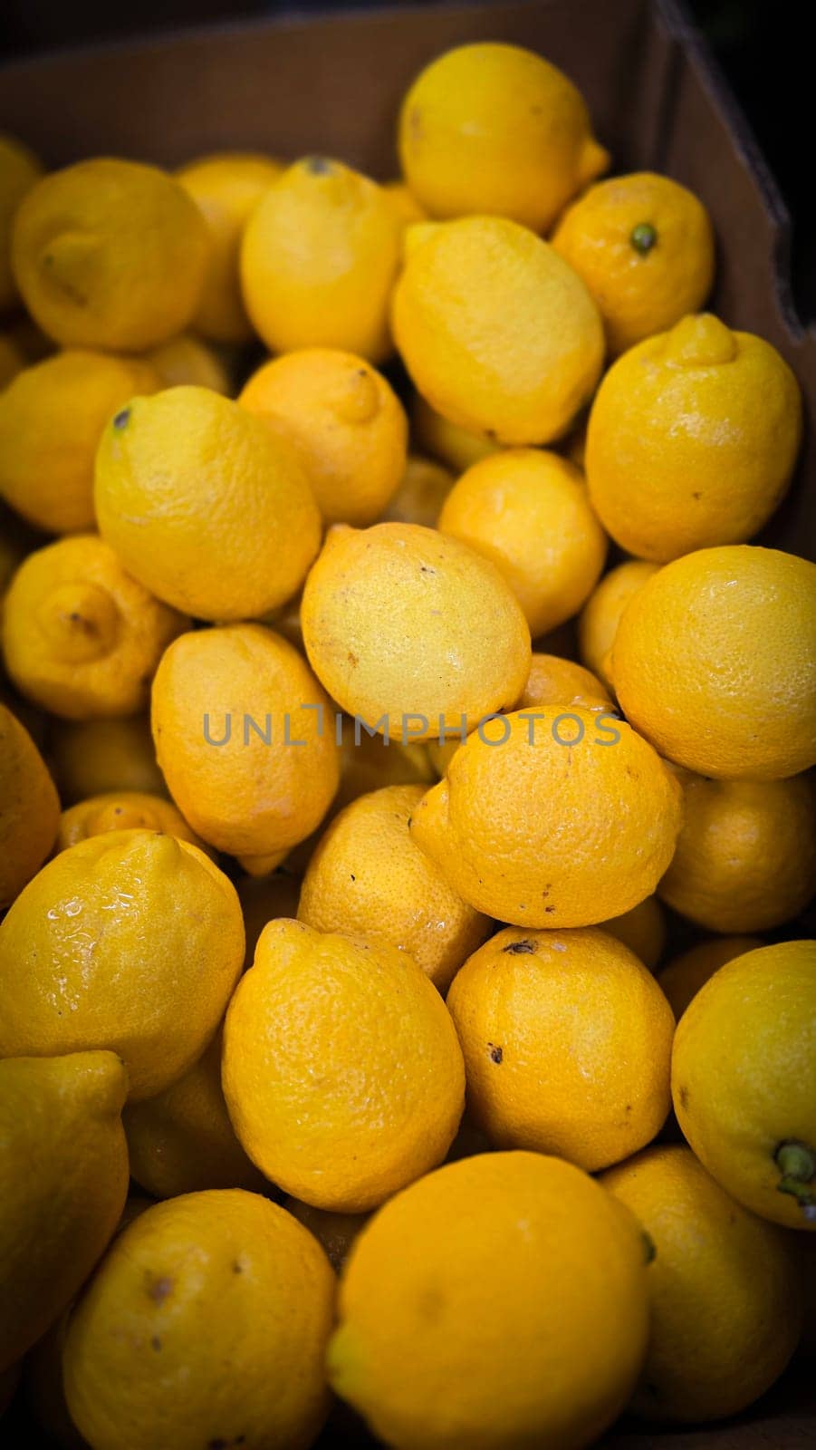 Bright yellow lemons grouped together, presenting an inviting and fresh appearance suitable for culinary or beverage uses, evoking sunny and refreshing vibes. Lemon stack. A vibrant image of fresh, ripe lemons top view. Rich vitamin c, natural and fresh lemon stack
