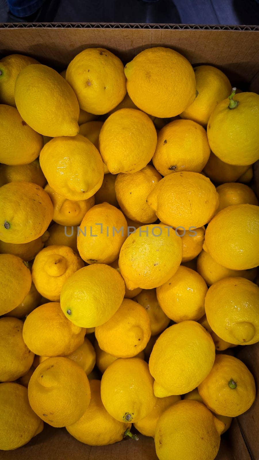 Bright yellow lemons grouped together, presenting an inviting and fresh appearance suitable for culinary or beverage uses, evoking sunny and refreshing vibes. Lemon stack. A vibrant image of fresh, ripe lemons top view. Rich vitamin c, natural and fresh lemon stack