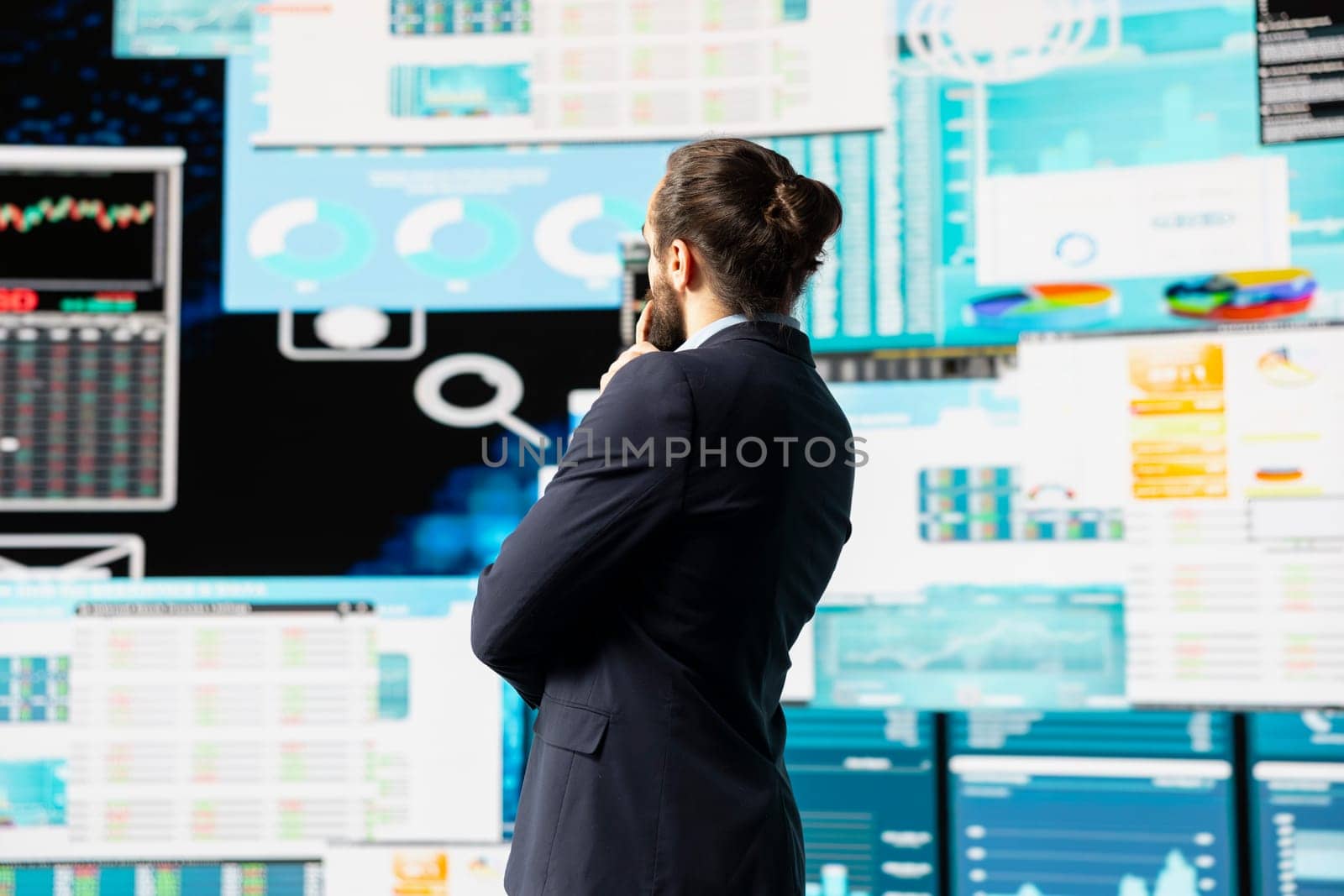 High end entrepreneur thinking about new powerful ideas for company profit growth, using analytics reports and KPI projections to guide his strategic decision making. Forecasting.