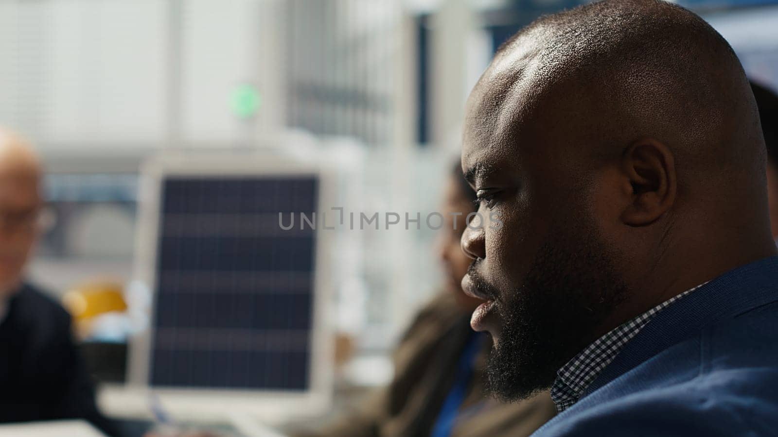 Photovoltaics plant engineering team works on breakthroughs in durability and performance in office. Teamworking research and development coworkers testing materials for next generation solar panels