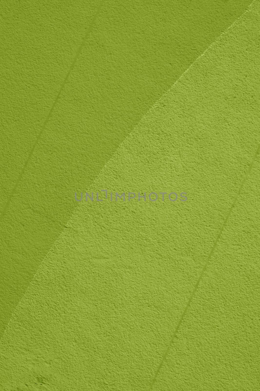 The background for the design is a wall painted in different shades of green.