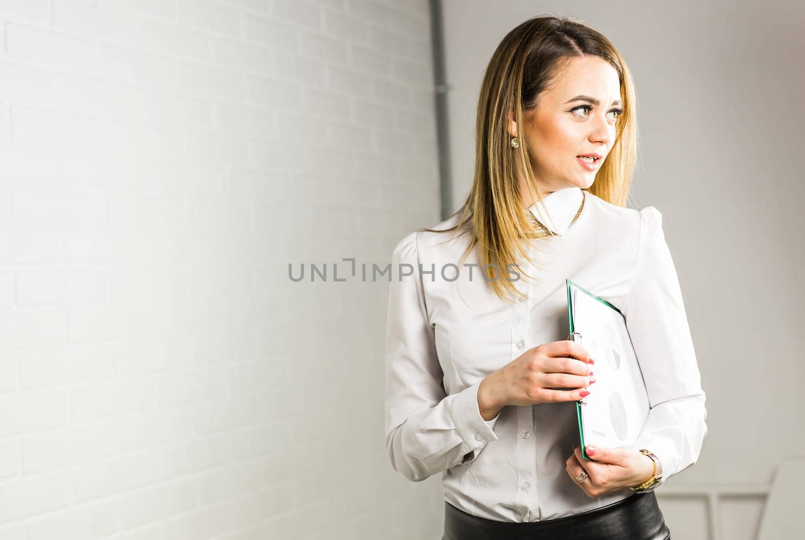 Portrait of business woman hold a folder.
