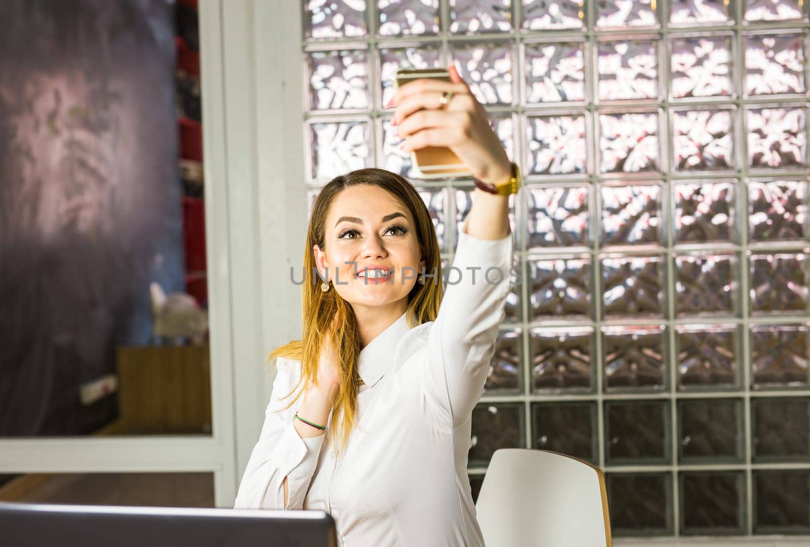 technology, photographing, and people concept - happy couple taking selfie with smartphone or camera on mall