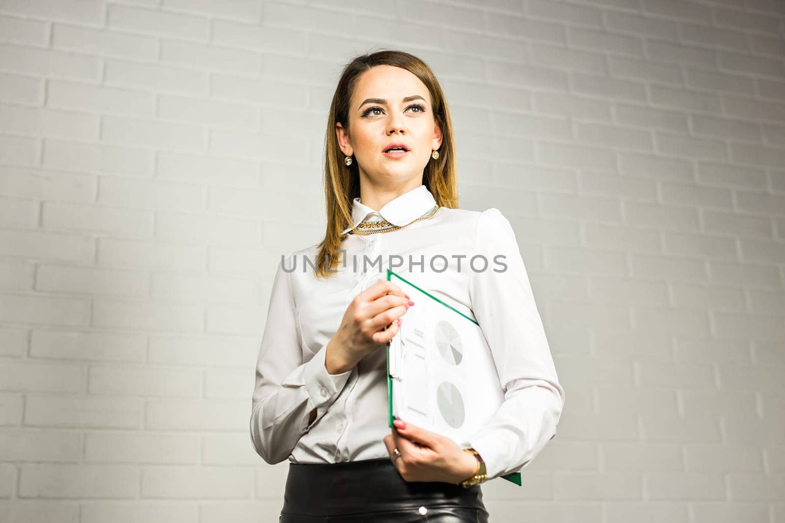 Portrait of business woman hold a folder.