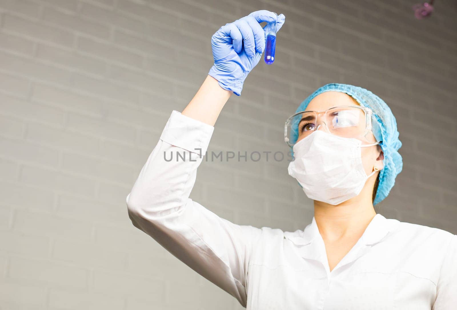 Attractive young female scientist working in laboratory.