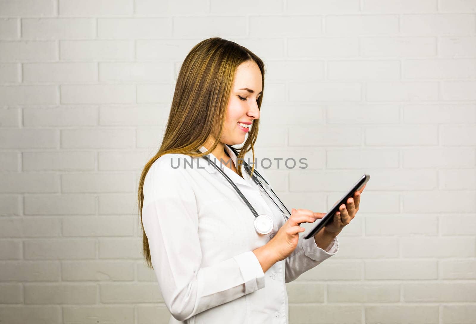 healthcare, technology and medicine concept - smiling female doctor with stethoscope and tablet pc computer